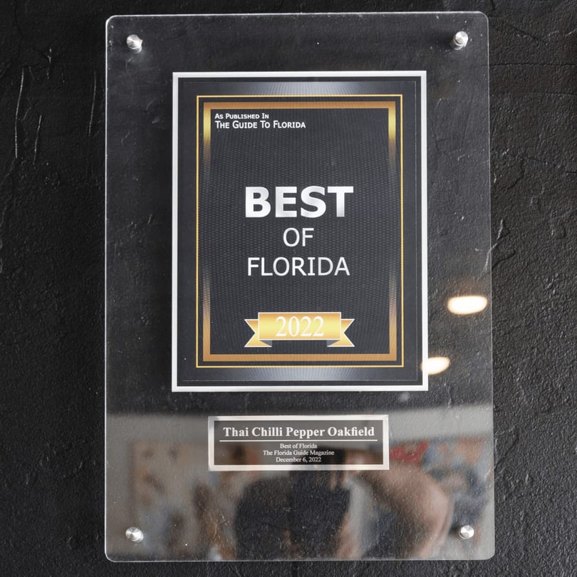 A framed "Best of Florida 2022" award from The Guide to Florida for Thai Chilli Pepper Oakfield.